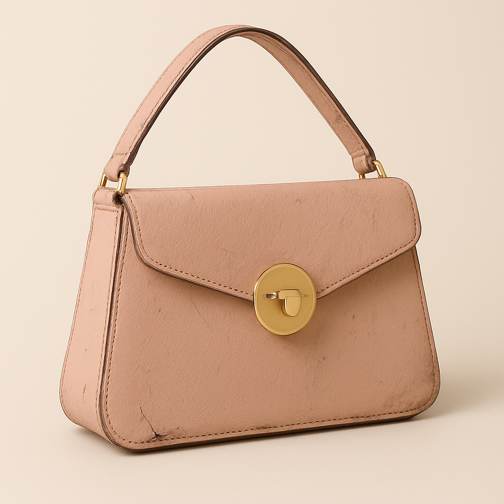 Pink leather handbag before restoration showing wear and scratches